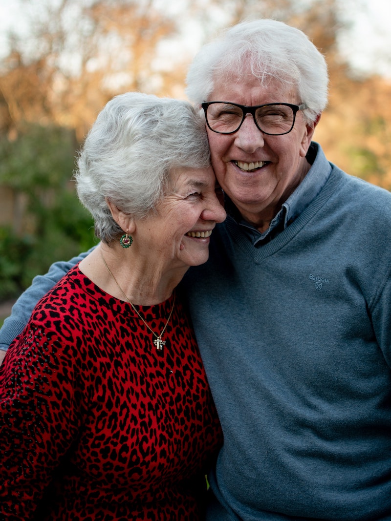 Smiling couple hugging in park